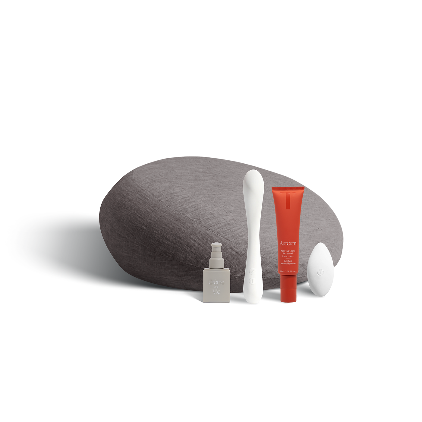A Prim in charcoal (dark gray), Crème de la Vie moisturizer, the Nuri massager, the 100ml Aureum, and the Pearl