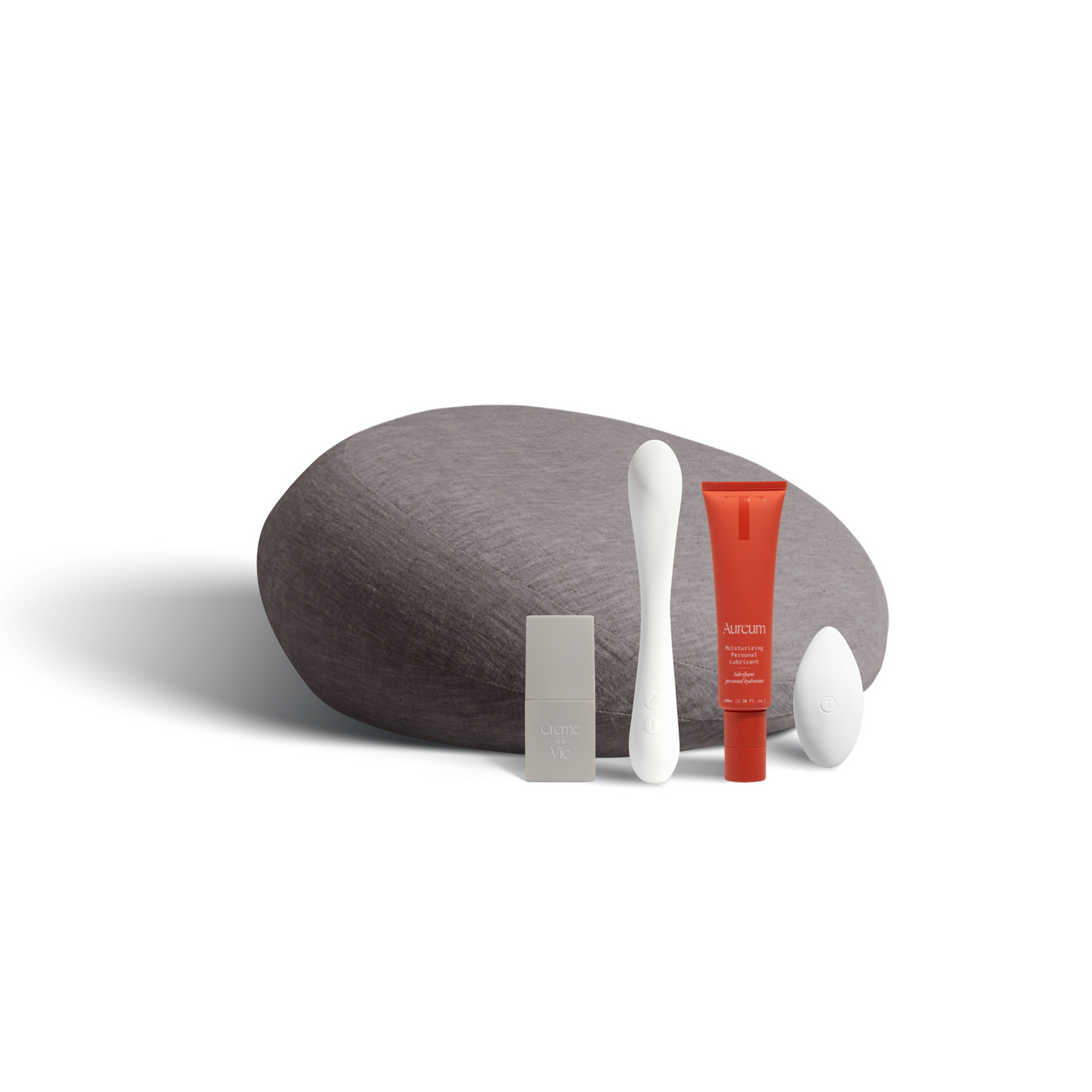 A Prim in charcoal (dark gray), Crème de la Vie moisturizer, the Nuri massager, the 100ml Aureum, and the Pearl